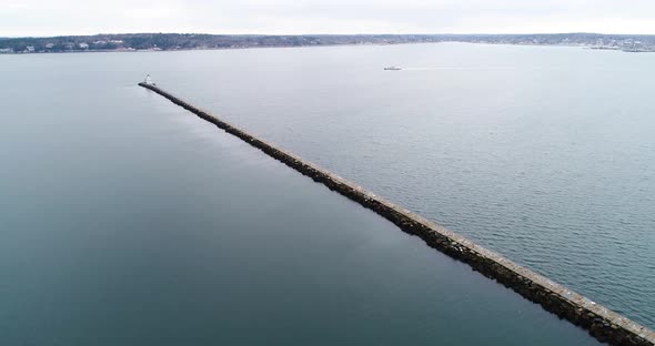 Birds eye view of the stone bridgeway to the Rockland Breakwater Lighthouse in Maine alt