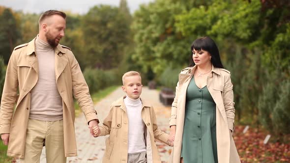 A Happy Family is Walking in the Park