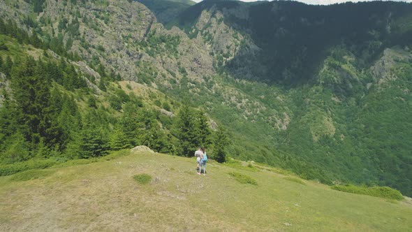 Hikers Enjoying the View From Mountain Summit alt