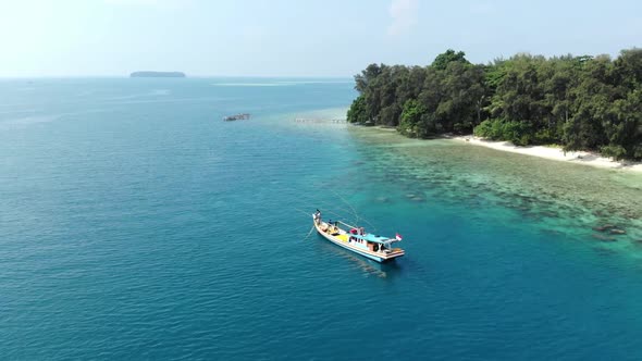 Aerial view of a beautiful island in the ocean with a boat