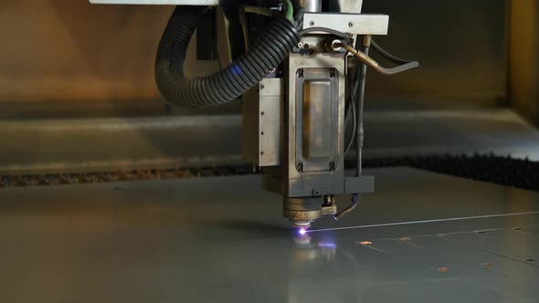 Laser cut machine while cutting the sheet metal with sparks and high precision alt