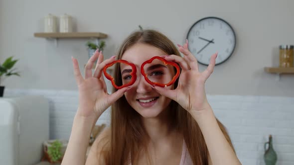 Girl Vegan Dancing Holding Fresh Red Slice of Bell Pepper on Eyes. Weight Loss and Diet Lifestyle alt