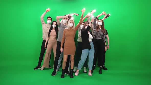 Crowd of People of Different Ages Dancing at a Music Concert People in Protective Medical Masks alt