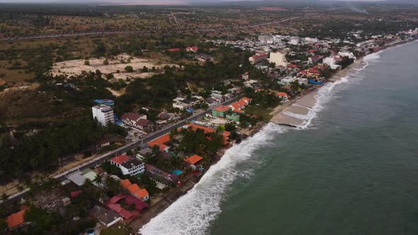 Aerial, climate change rising sea levels eroding coastal Southeast Asia village alt