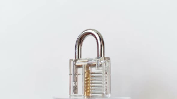 Transparent Padlock Rotating on White Background alt
