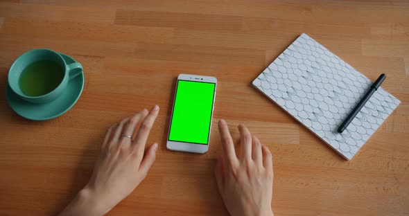 Slow Motion of Woman's Hands Moving on Table with Green Screen Smartphone alt