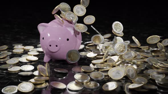 Falling Euro Coins on the Money Box Pig and Marble Tiles Floor