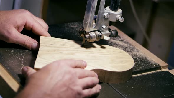 Closeup Hands of Male Carpenter Working on Milling Machine with Wood Detail