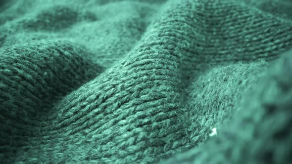 Extreme detail view of sheep wool cloth texture flowing in macro dolly shot. alt