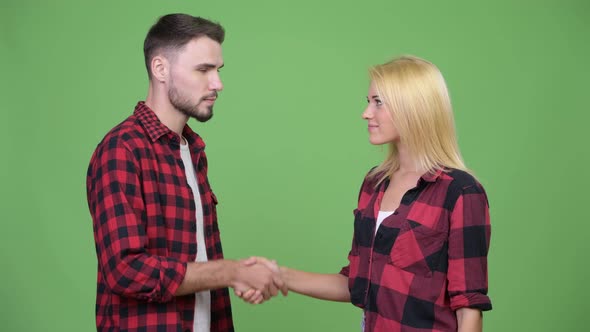 Young Couple Shaking Hands Together