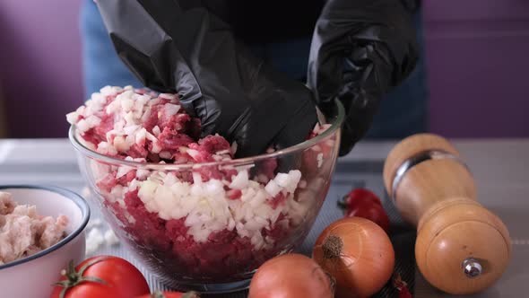 Kneading of Minced Meat with Onion and Spices in a Glass Bowl alt
