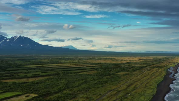 Beach with Black Sand and Volcano alt