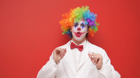Playful Clown Makes Grimaces on an Isolated Background