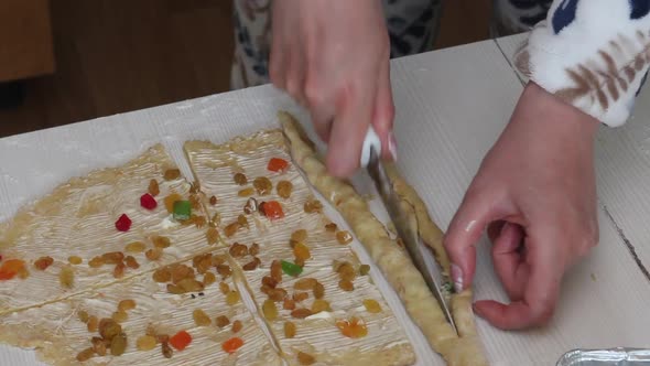 A Woman Prepares A Cruffin With Raisins And Candied Fruits. alt