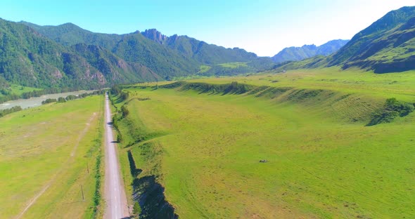 Aerial Rural Mountain Road and Meadow at Sunny Summer Morning alt
