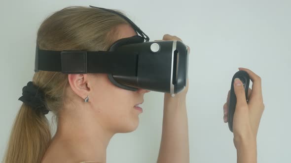 Sexy Beautiful Woman Uses A Virtual Reality Helmet In A Simulation Game
