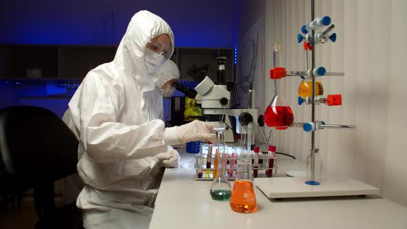 Scientist Examining Samples with Microscope