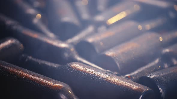 Lots of cold beer bottles covered with drops.