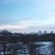 Flying over a snowy park. The city is visible on the horizon. Aerial photography. - VideoHive Item for Sale
