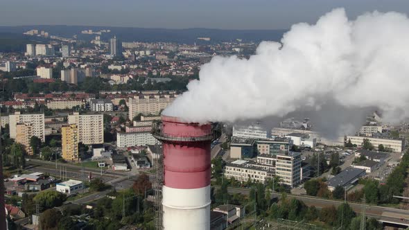 Aerial view of high chimney pipe with white smoke from coal power plant alt