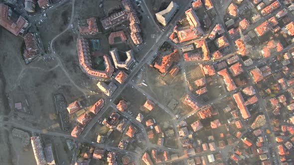 aerial footage viewing the red roofs of a village during sunny morning