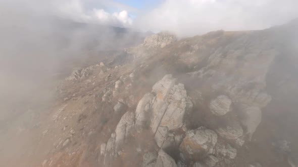 Shooting From Sports Fpv Drone Flying Over Mount Katyusha with Dense Natural Fog Over City alt