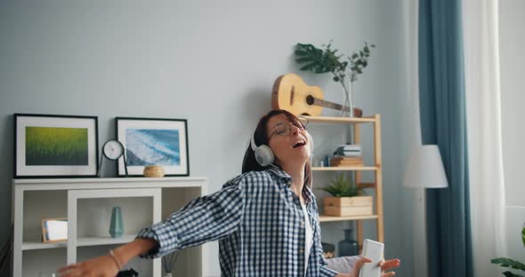 Funny Girl Singing Dancing Listening To Music in Headphones Holding Smartphone alt