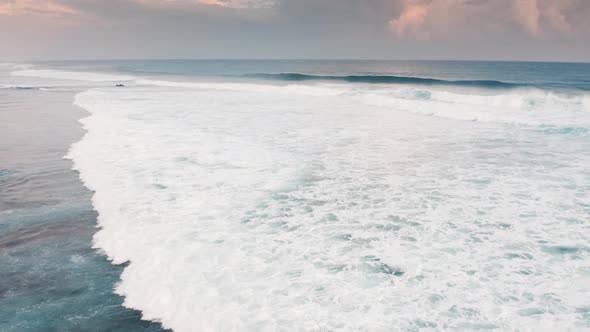 Static Aerial View of Green Waves Breaking As They Roll to Sea Shore alt