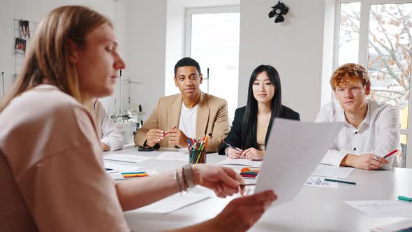 Group of Young Multiethnic Creative Designers Discussing New Project During Business Meeting at alt