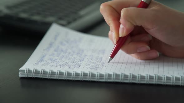 Business Woman Writing with Pen in Her Notepad alt
