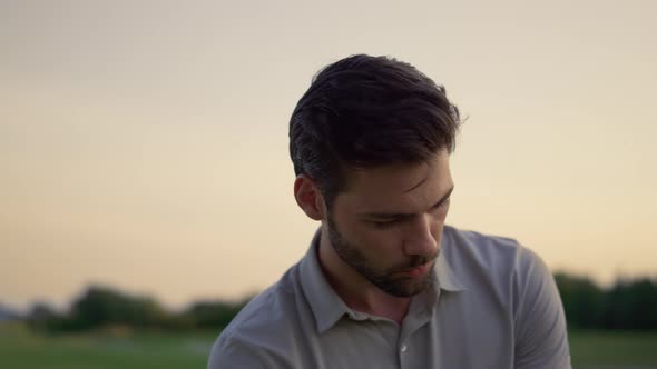 Handsome Man Celebrate Successful Golf Game on Sunset Nature Fairway Course alt