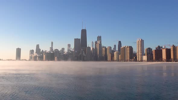timelapse of sea smoke on Lake Michigan with Chicago skyline in the morning sunlight alt