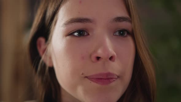 Pretty Young Woman with Mole Near Lip Looks Hopefully alt