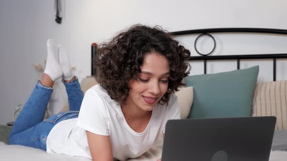 Smiling Hispanic Curly Woman Student Study Uses Laptop Distance Education alt