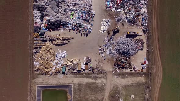 Aerial top down satellite view scroll of recycling yard