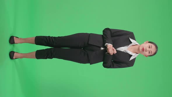 Full Body Of Asian Businesswoman Standing And Presenting Something On The Green Screen alt
