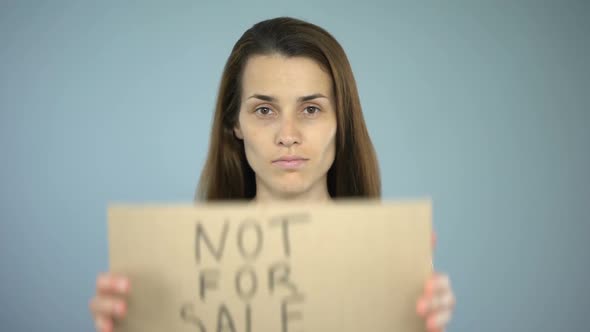 Not for Sale Sign in Woman's Hands, Sexual Slavery, Human Trafficking, Assault alt