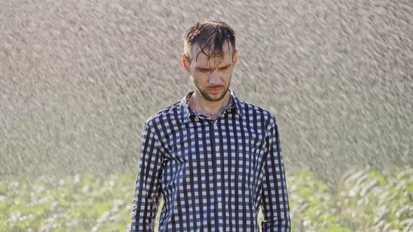 Portrait of Sad Man Standing Under the Rain. Super Slow Motion