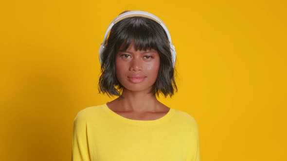 Young Dark Skinned Female Catches Every Bit of Song Wears Stereo Headphones alt