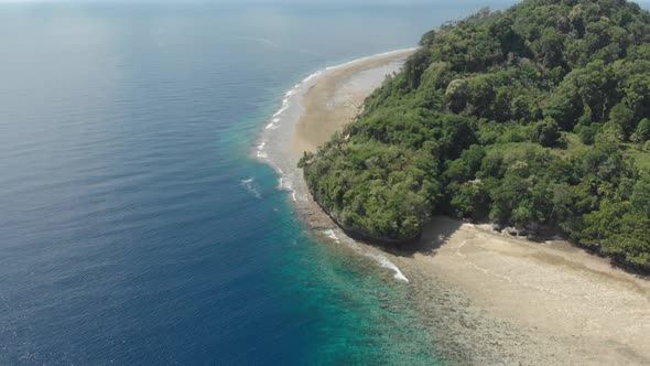 Aerial: flying over tropical Ai island white sand beach Banda Islands Indonesia alt