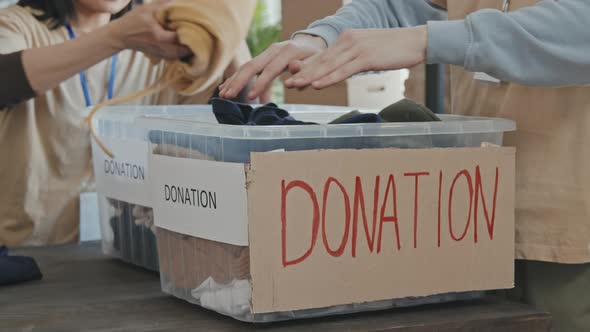 Putting Donated Items in Charity Boxes alt