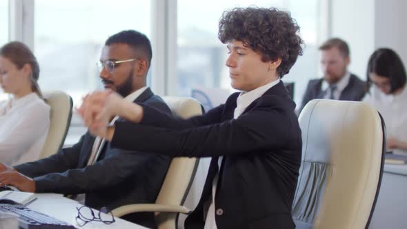Female Worker Doing Exercises in Office alt