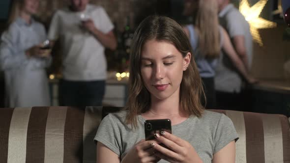 Portrait young beautiful girl Christmas party, girl looks at camera and smiles alt