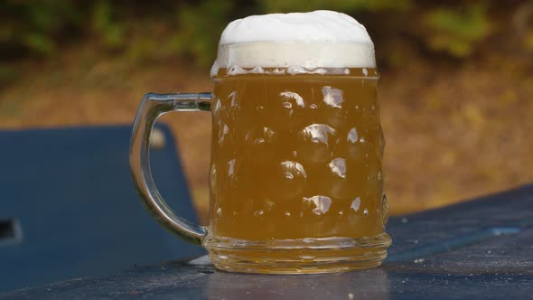Delicious bottle of beer flows into a classic German beer glass