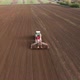 Tractor in Working in the Field. Tractor with a Modern Sowing Seeds Machine in a Newly Plowed Field - VideoHive Item for Sale