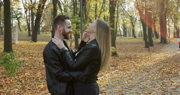 Lovely Couple Laughing and Having Fun While Standing in Embraces in Autumn Park alt