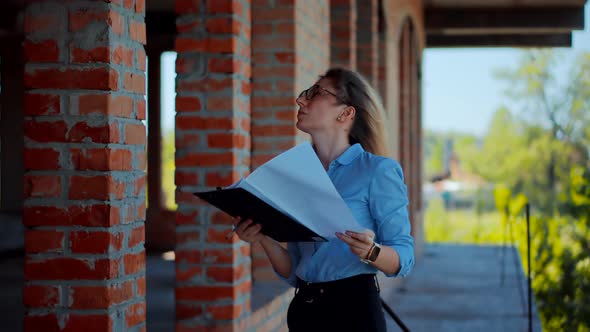 Designer On Construction Site. Builder Contractor Specialist Read Plan Scheme. Civil Engineer. alt