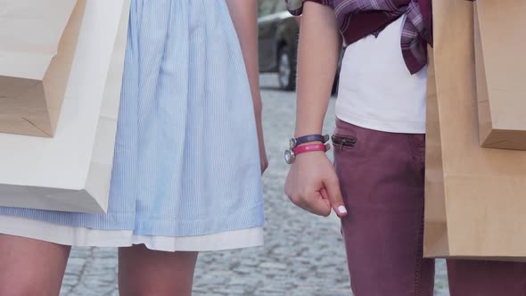 Cropped Shot of Two Female Friends Holding Hands alt