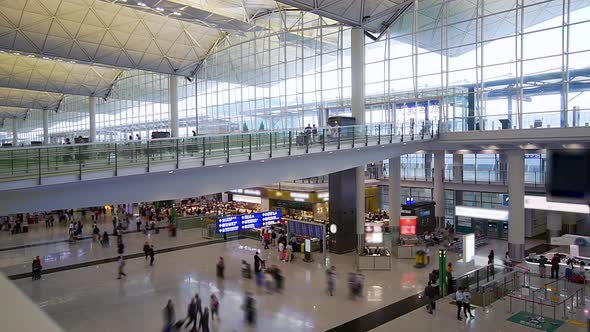 Travelers Tourists in Hong Kong Airport Terminal  alt