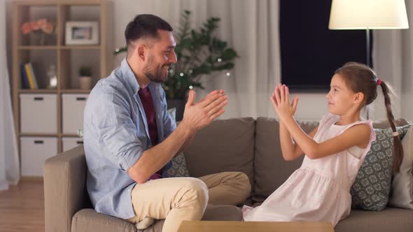 Father and Daughter Playing Clapping Game at Home 6 alt